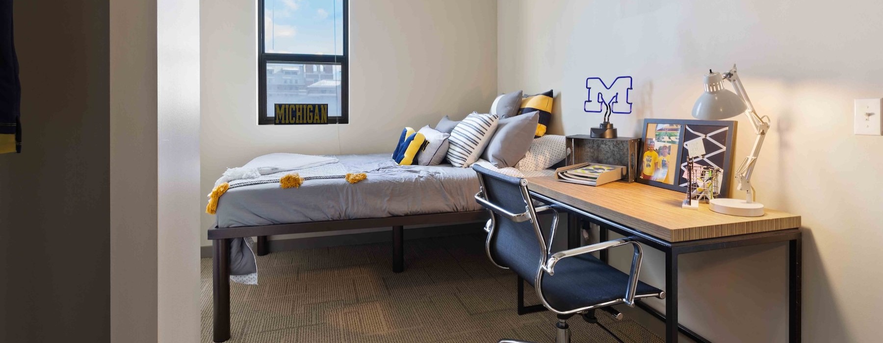 a bedroom with a desk and chair